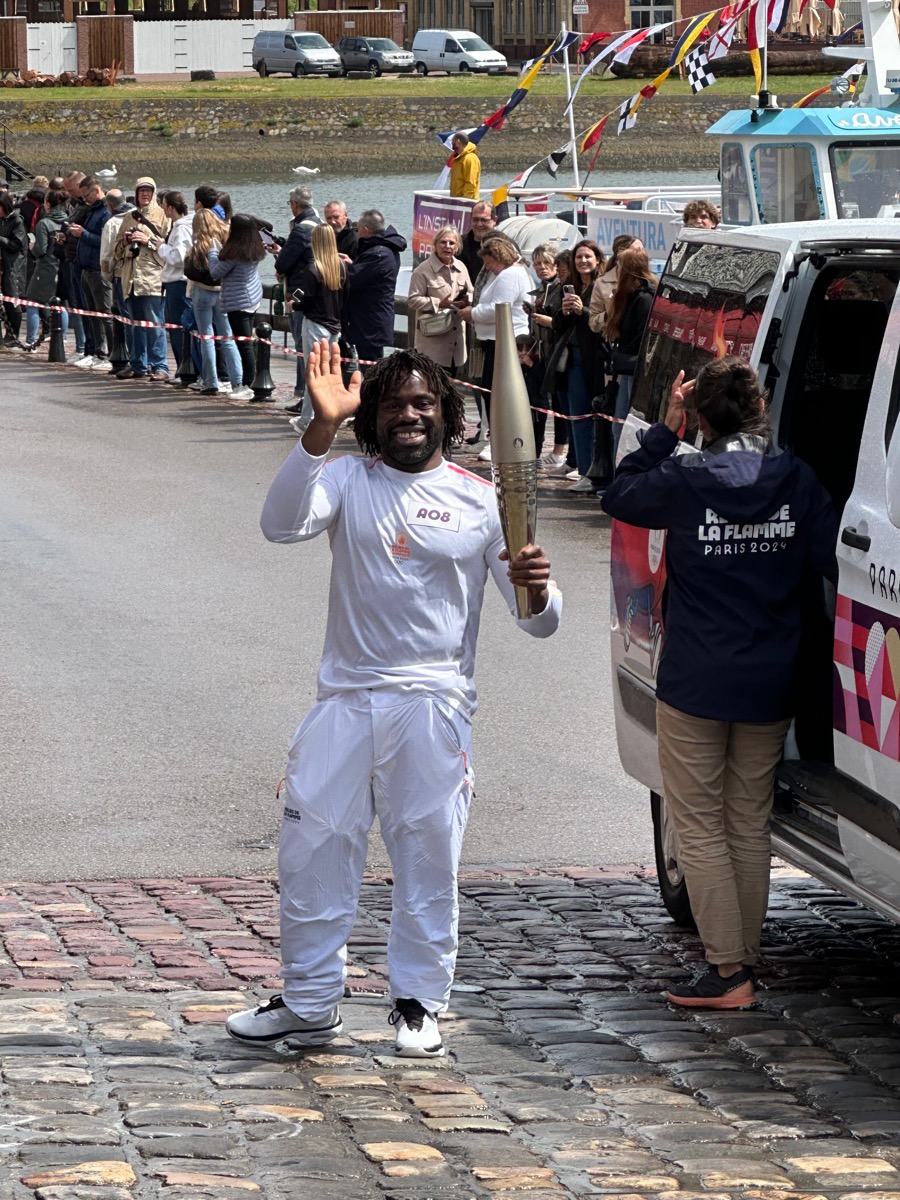 Bboy Junior carrying the Olympic flame