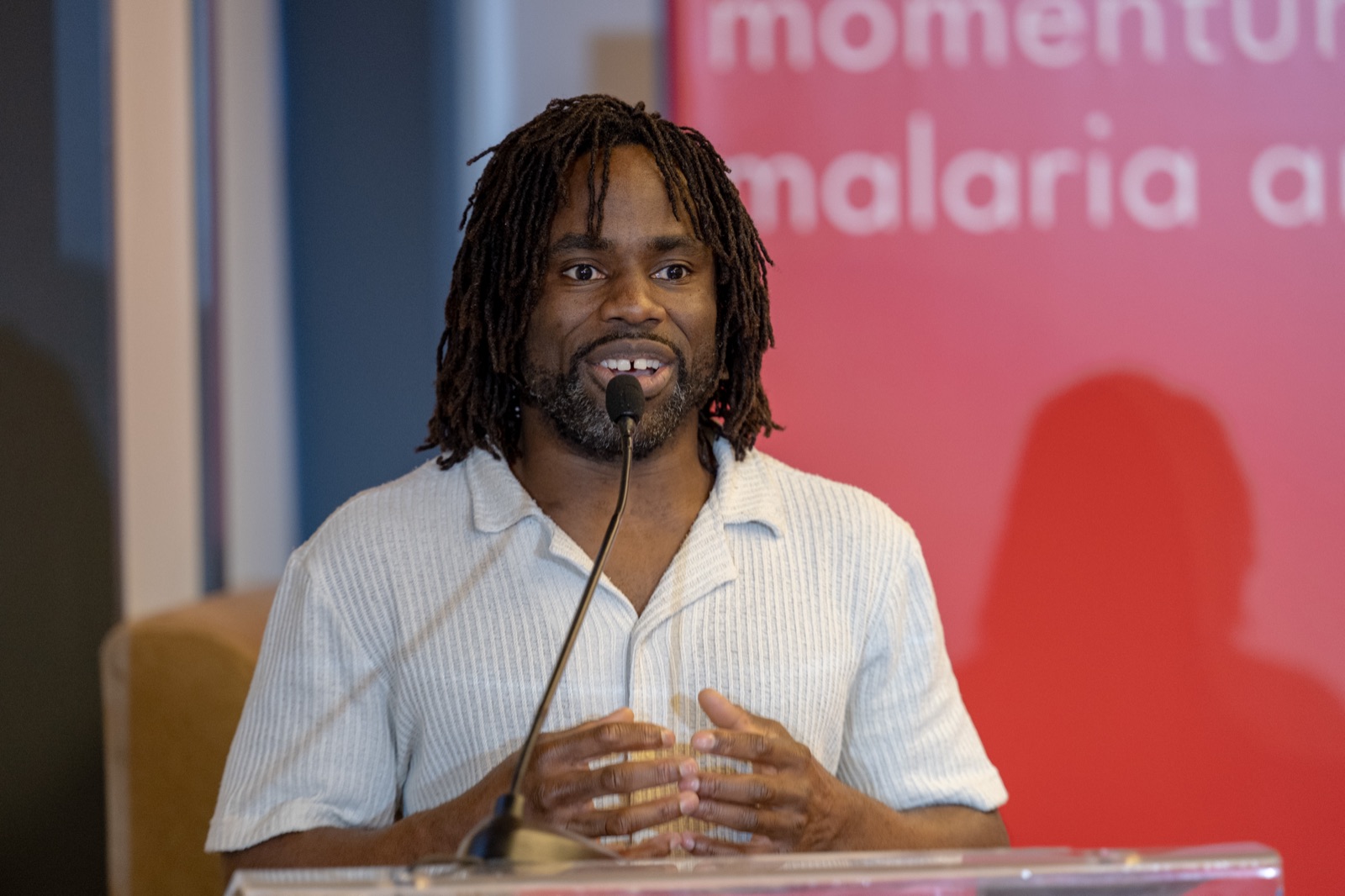 Bboy Junior speaking at a podium